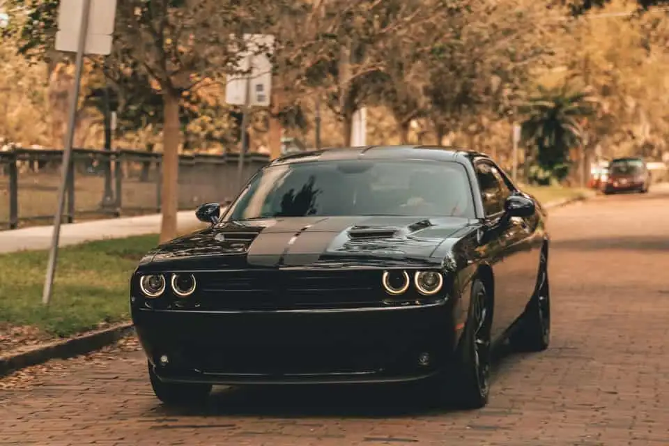 black car driving on alley