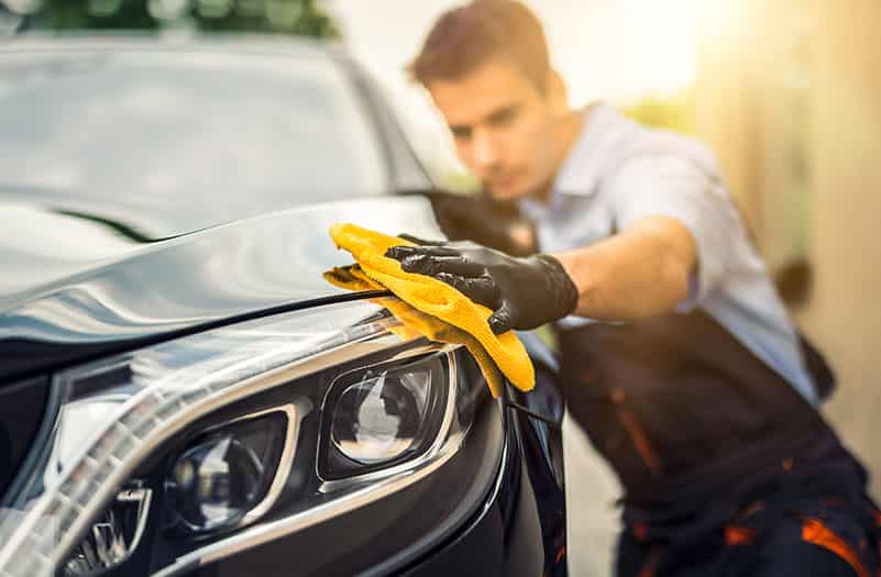 detailer cleaning a Mercedes Benz