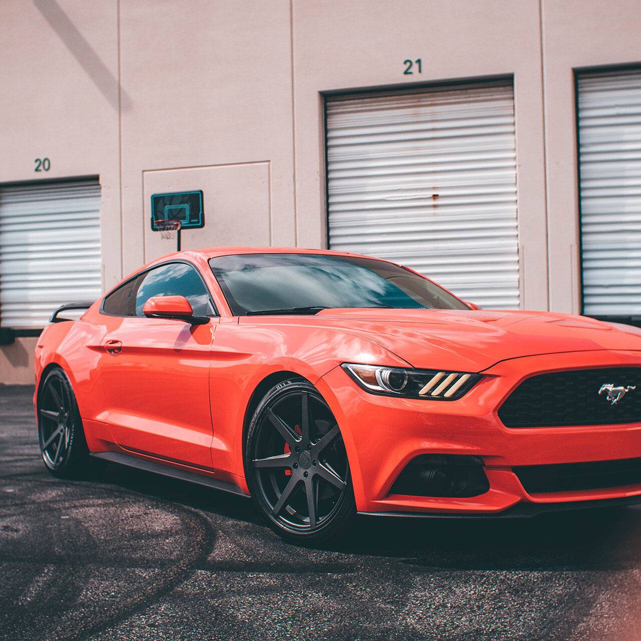 red ford mustang in a industrial area